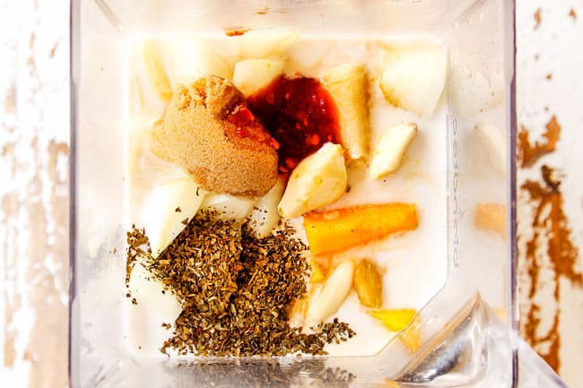 showing how to make mango chicken by adding mangos, coconut milk, lime juice, soy sauce, fish sauce, garlic and ginger to a blender