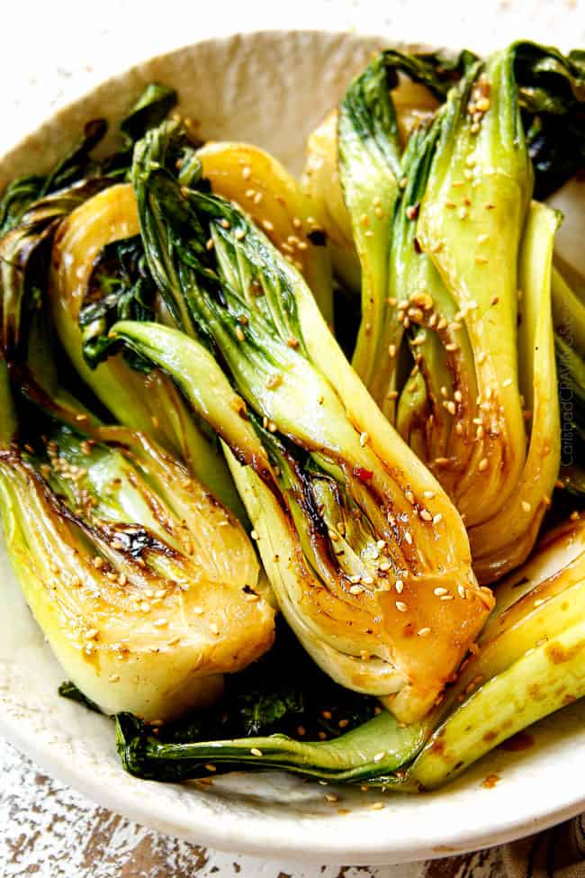 bok choy recipe in a white bowl glazed with sesame soy glaze
