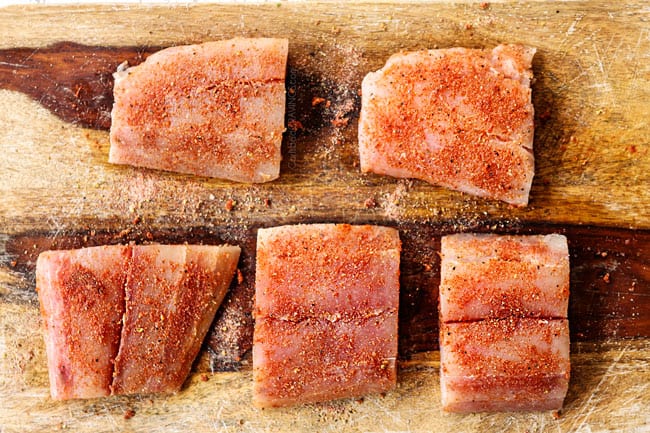 showing how to cook mahi mahi by seasoning with paprika, onion powder, garlic powder, salt and pepper on a cutting board