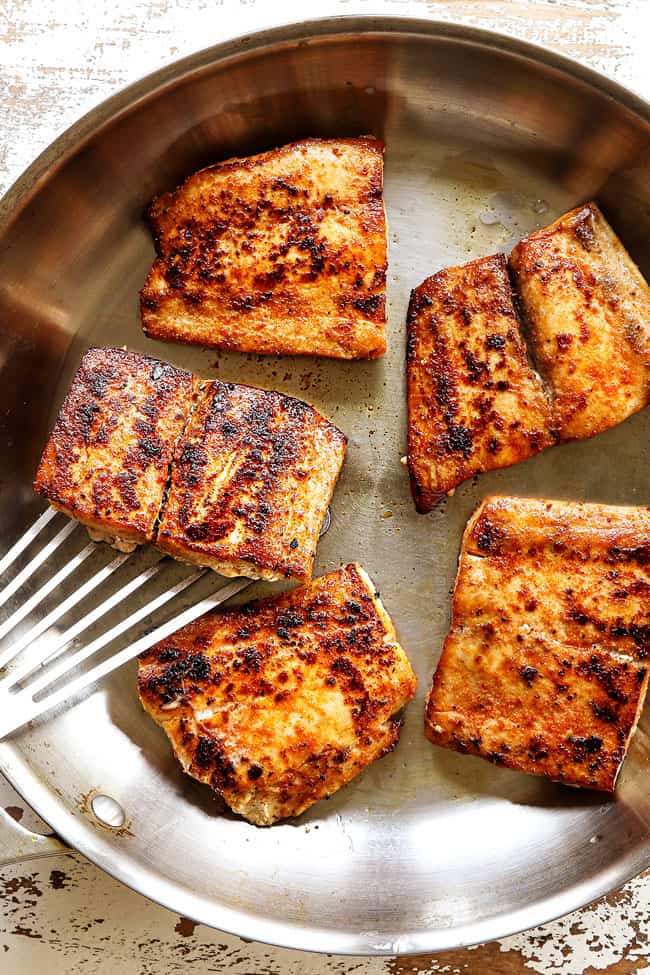 showing how to make mahi mahi by searing mahi mahi in a stainless steel skillet