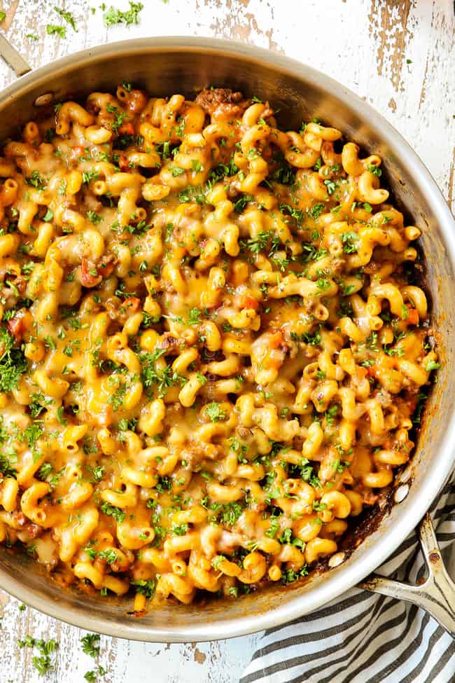 top view of a homemade hamburger helper recipe covered in cheese garnished with parsley