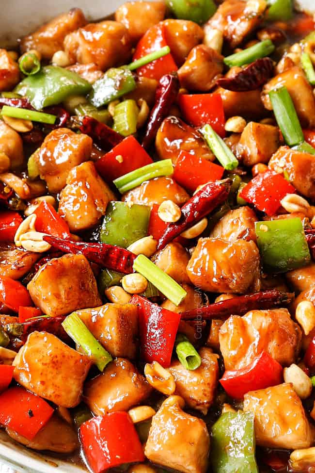 up close of best kung pao chicken recipe in a white skillet showing how juicy the chicken is