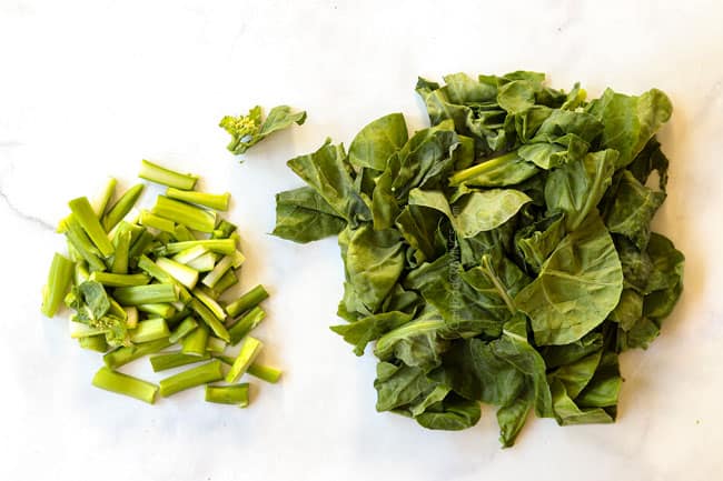 showing how to make pad see ew recipe by separating the Chinese broccoli stalks and leaves on a cutting board