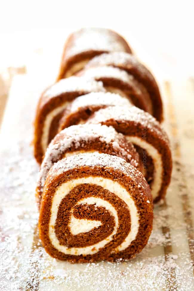 showing how to make a pumpkin roll by slicing into 1-inch slices