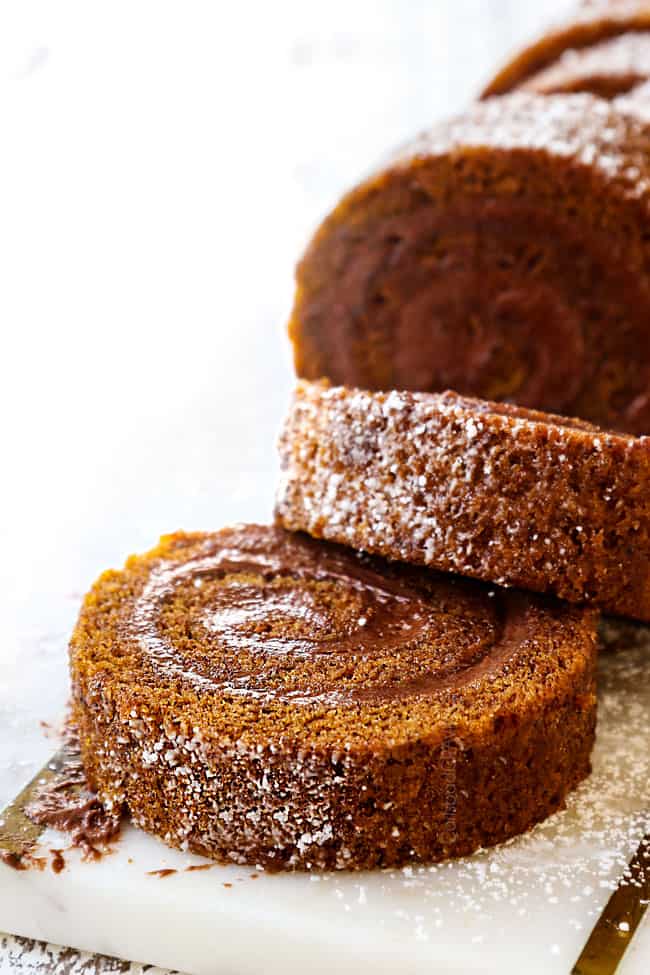 a slice of best pumpkin roll recipe on a white cutting board