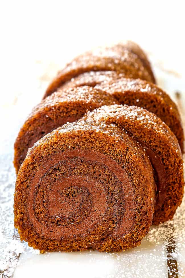 front view of pumpkin roll on a white cutting board
