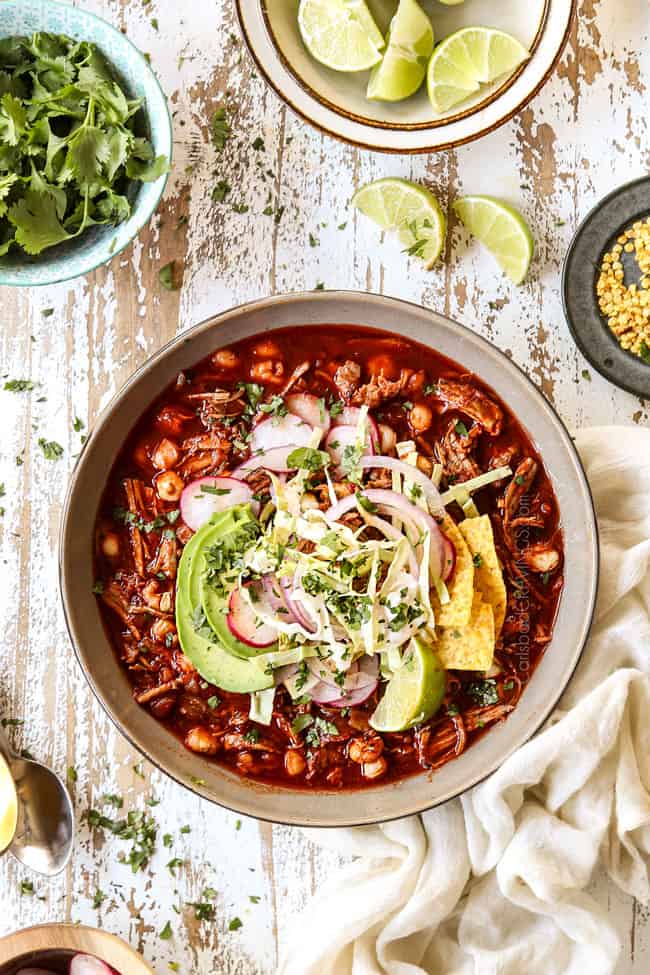 showing how to garnish pozole soup with a top view of pozole soup with cabbage, radishes, cilantro, red onions