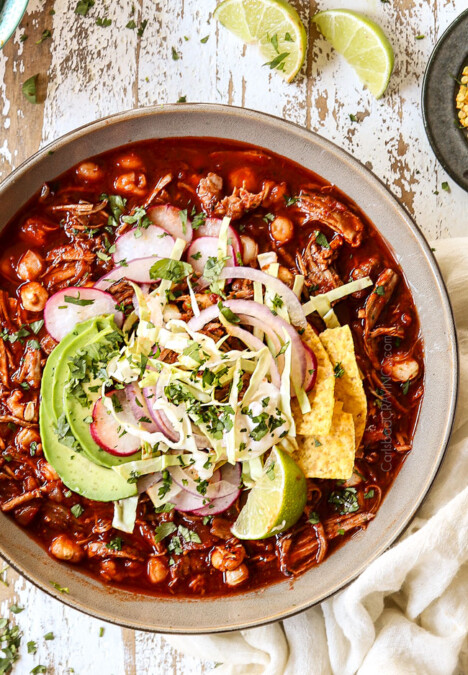 showing how to garnish pozole soup with a top view of pozole soup with cabbage, radishes, cilantro, red onions