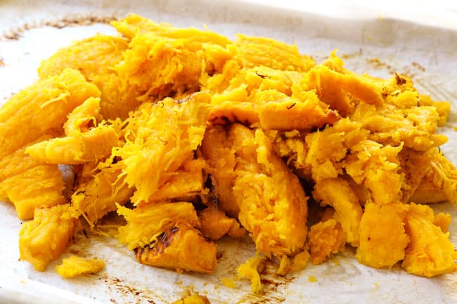 showing how to make pumpkin coconut soup by removing the skin from the pumpkins to reveal the flesh