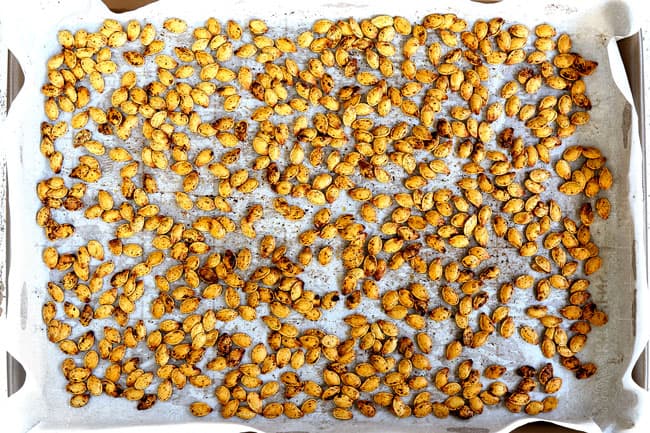 showing how to make pumpkin soup by roasting pumpkin seeds on a baking sheet with cinnamon, sugar, and salt