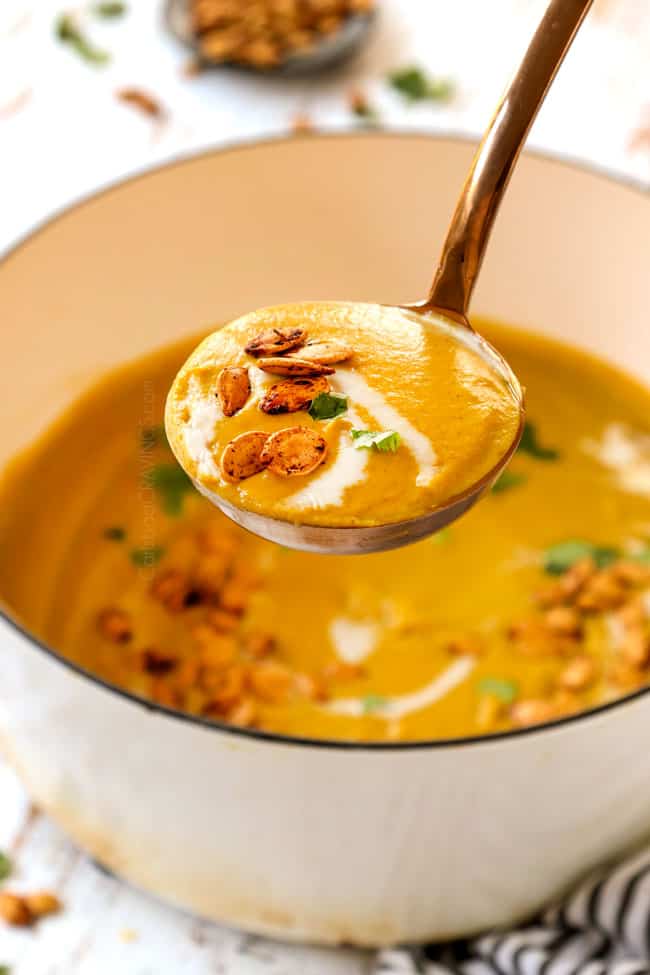 picking up a ladle pumpkin soup recipe showing how creamy it is