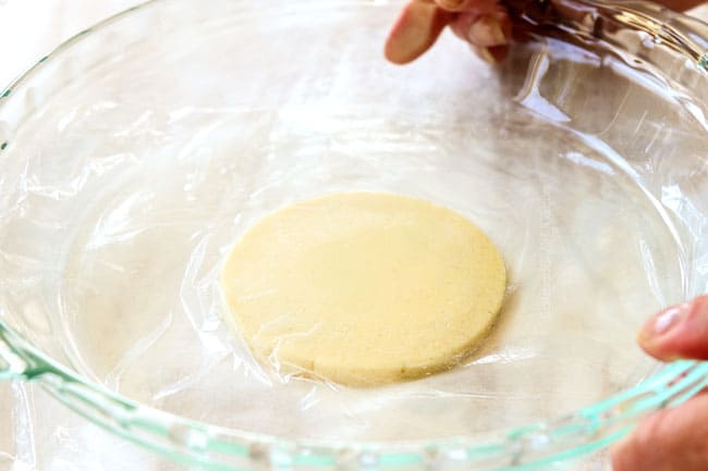 showing how to make Mexican sopes by flattening dough by covering with plastic wrap and pressing down with a pie plate