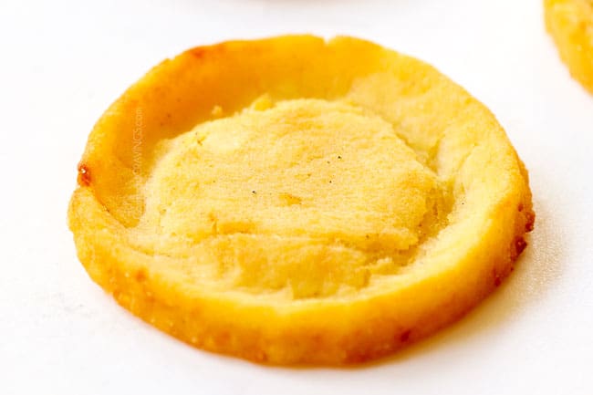 showing how to make sopes by draining fried sopes on paper towels