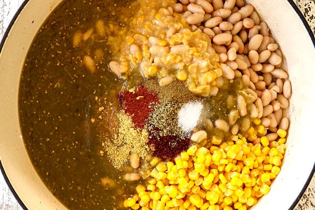 showing how to make best white chicken chili recipe by adding white beans, creamed corn, salsa verde, chicken and chicken broth to a soup po