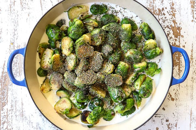 showing how to make creamy Brussel sprouts by adding heavy cream, chicken broth and Italian seasonings to the pan with the Brussel sprouts