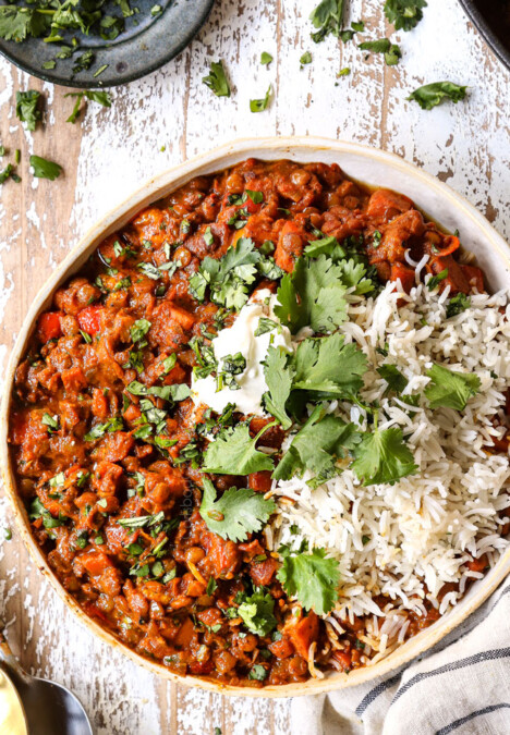 top view of lentil curry in a bowl with white rice and cilantro