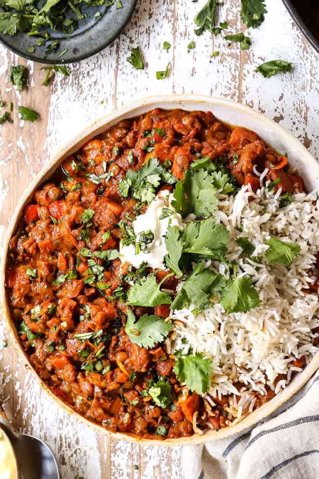 top view of lentil curry in a bowl with white rice and cilantro