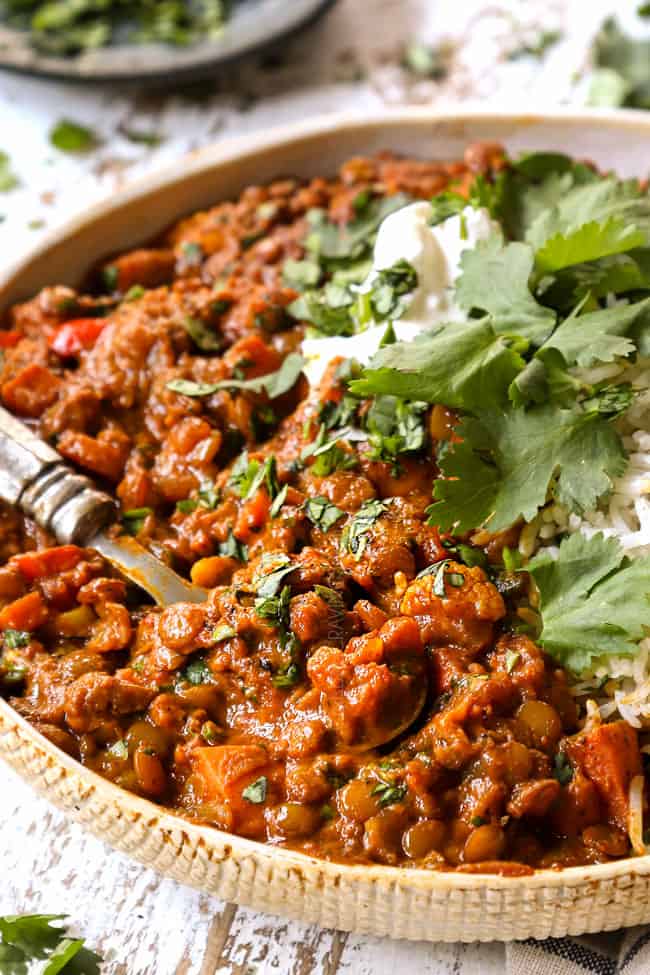 up close of lentil curry in a cream bowl showing how thick and creamy it is
