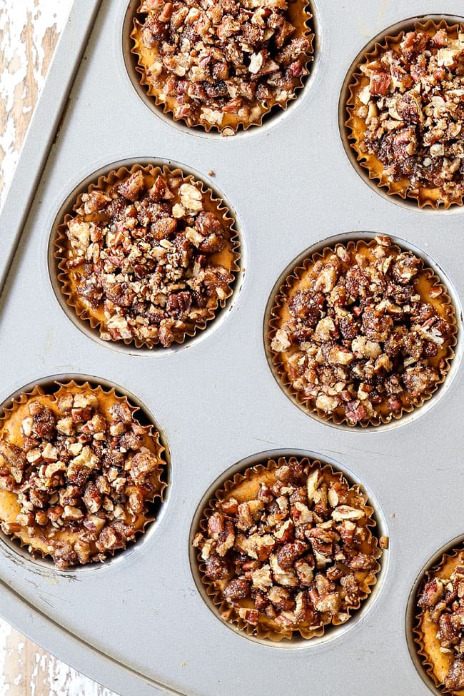 top view of mini pumpkin cheesecakes in a muffin tin