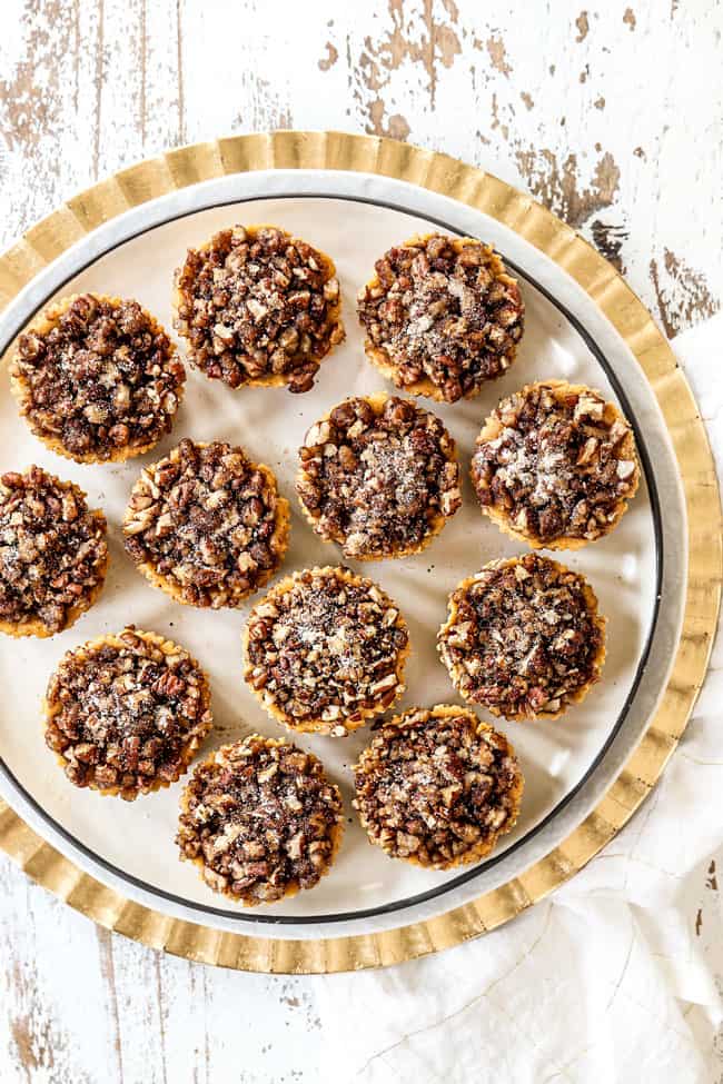 top view of mini pumpkin cheesecakes on a white plate
