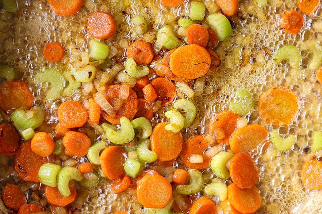 showing how to make chicken pot pie with biscuits by sauteing onions, carrots and celery until tender