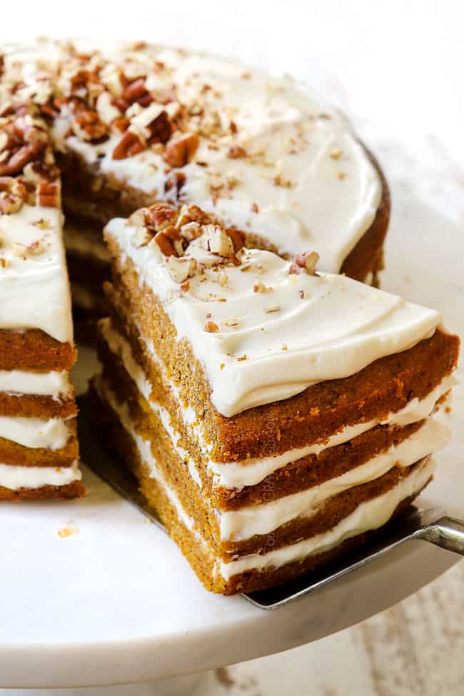 lifting a piece of pumpkin spice cake with a cake server