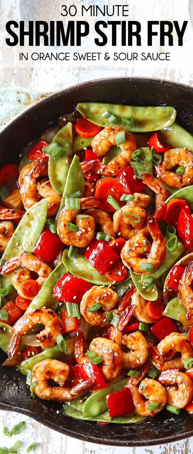 top view of shrimp stir fry recipe in a skillet garnished by green onions