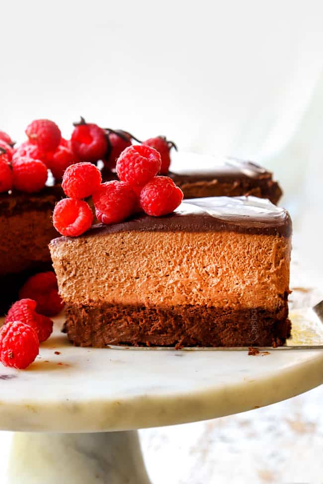 a slice of Chocolate Mousse Cake recipe on a white pedestal