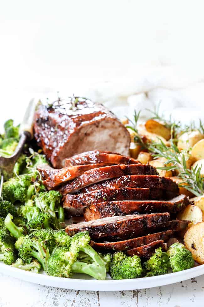 crockpot pork loin recipe sliced on a platter with broccoli anad potatoes