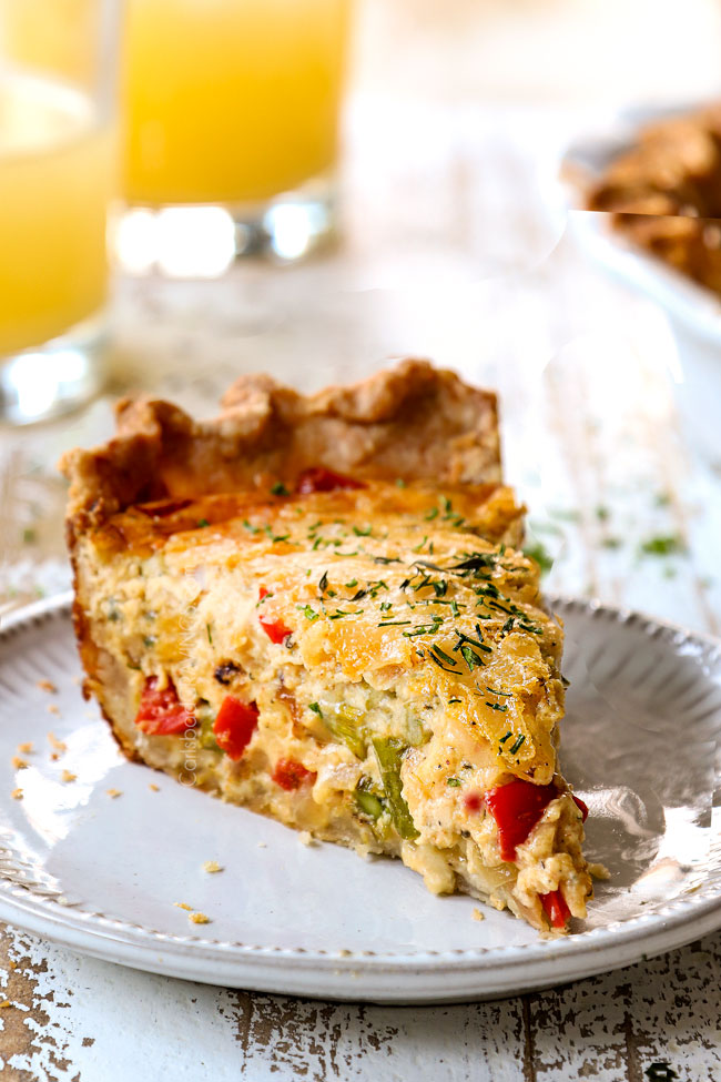 up close of a slice off ham and cheese quiche on a white plate