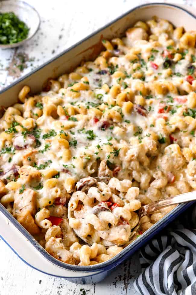 a pan of Cajun Chicken Alfredo with a scoop laying in the pan showing how creamy it is