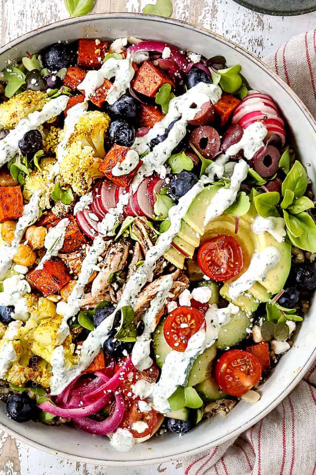top view of showing how to make rice bowl by drizzling with cilantro yogurt sauce