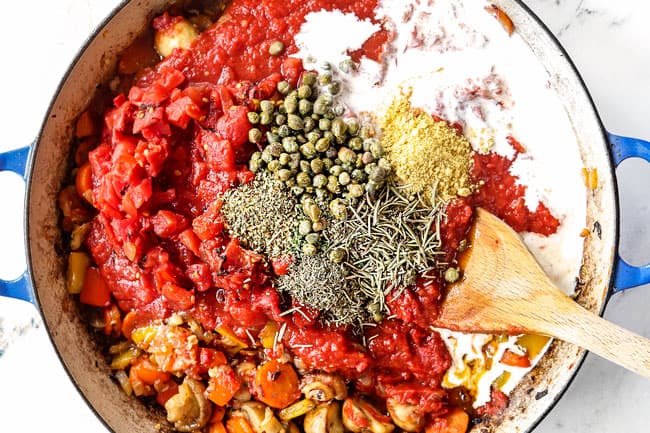 showing how to make chicken cacciatore recipe by adding crushed tomatoes, diced tomatoes, Italian seasonings and heavy cream to the pot