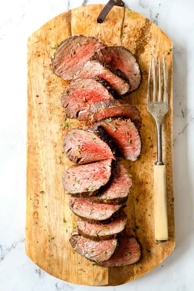 top view of a beef tenderloin roast on a wood cutting board