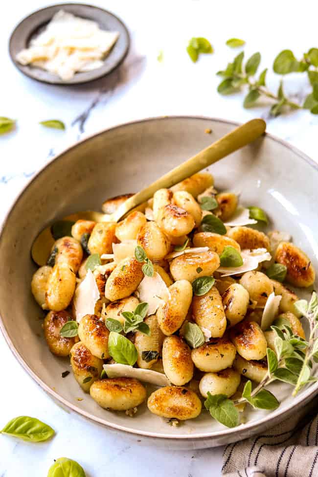 gnocchi with sauce in a bowl with sage