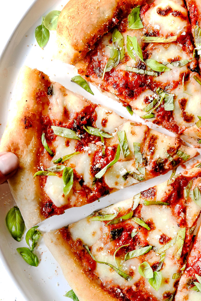 showing margherita pizza toppings on pizza: pizza sauce, fresh mozzarella, fresh basil and Parmesan