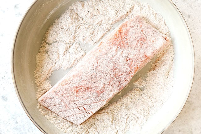 showing how to make Tuscan salmon by dredging salmon in flour