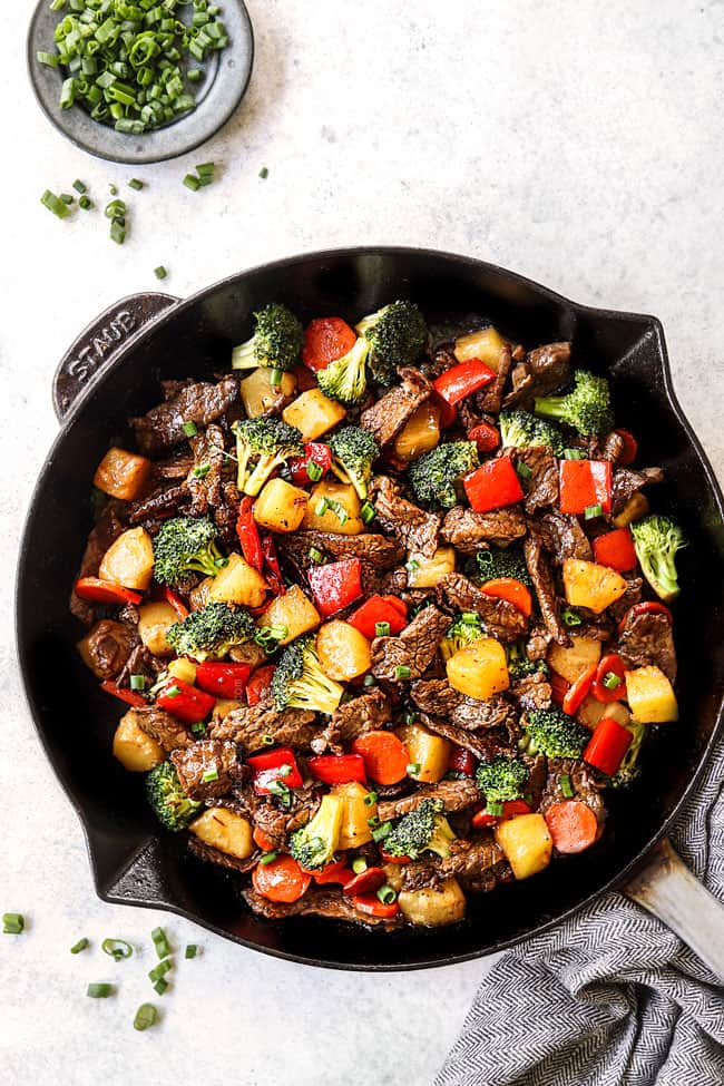 top view of beef teriyaki recipe in a skillet garnished with green onions