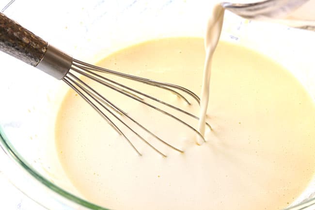 showing how to make creme brulee by tempering eggs by pouring heavy cream into sugar/egg mixture