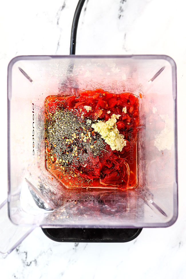 showing how to make pizza sauce by adding diced tomatoes, tomato past, garlic, olive oil, basil, oregano, thyme and red pepper flakes to blender