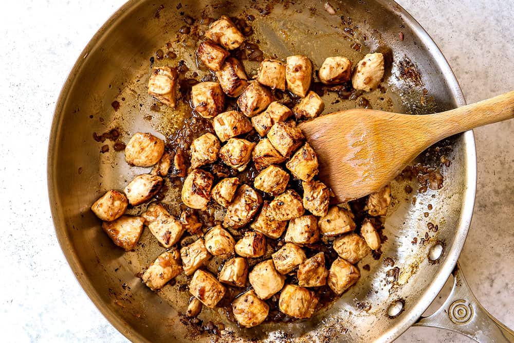 howing how to make balsamic chicken by cooking the chicken and shallot in a stainless steel skillet