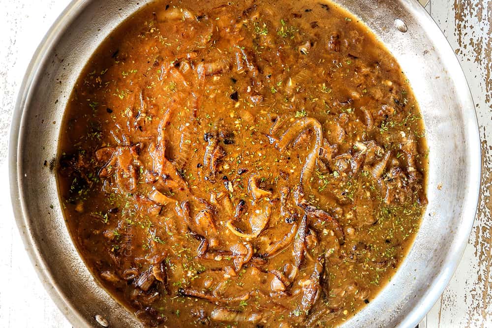 showing how to make French Onion Chicken recipe by adding beef broth and seasonings to a skillet to make the sauce