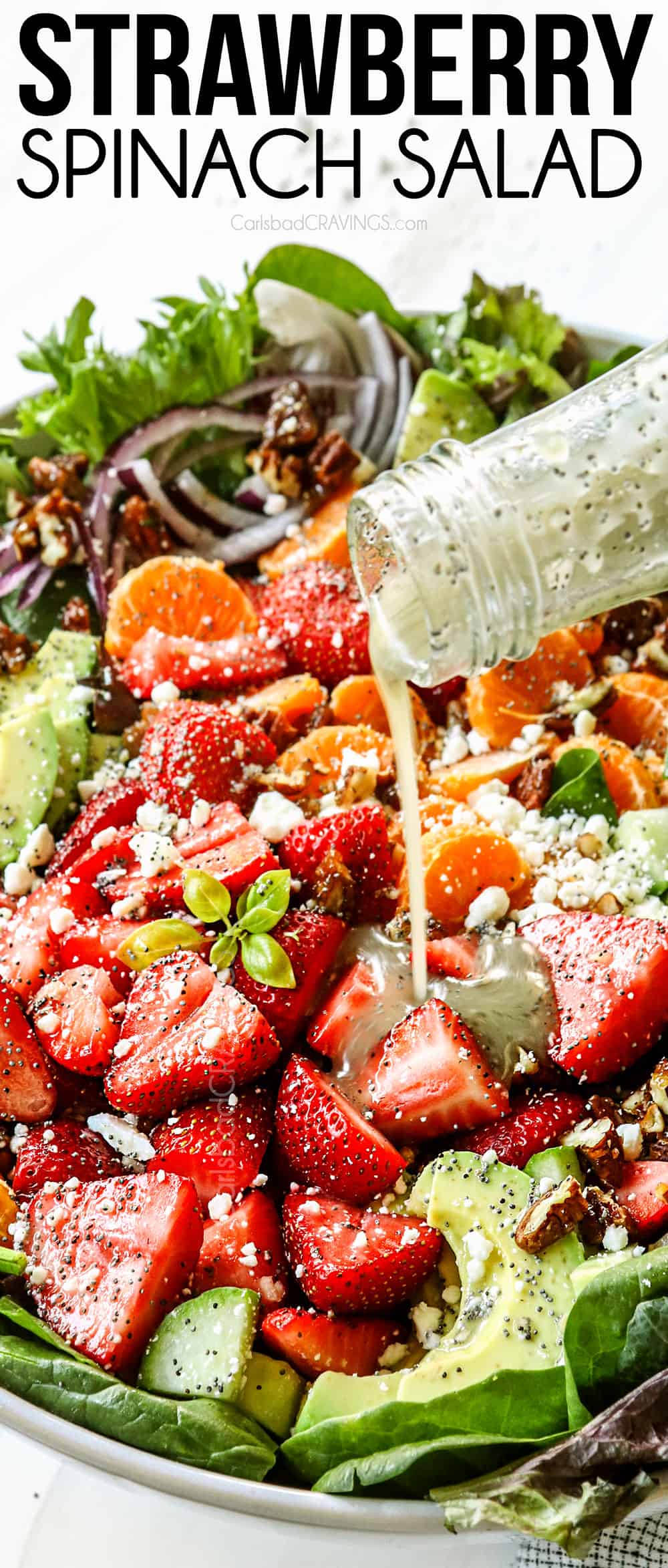 showing how to make strawberry spinach salad by drizzling with strawberry spinach salad dressing