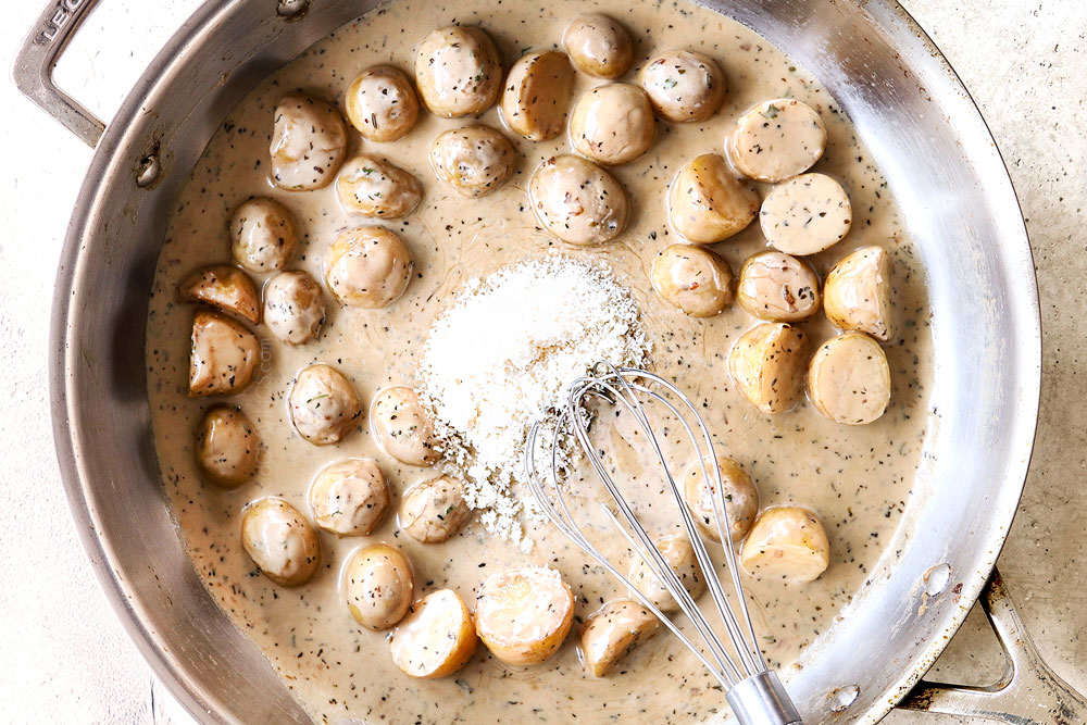 showing how to make Chicken mushroom recipe by making creamy sauce by adding Parmesan
