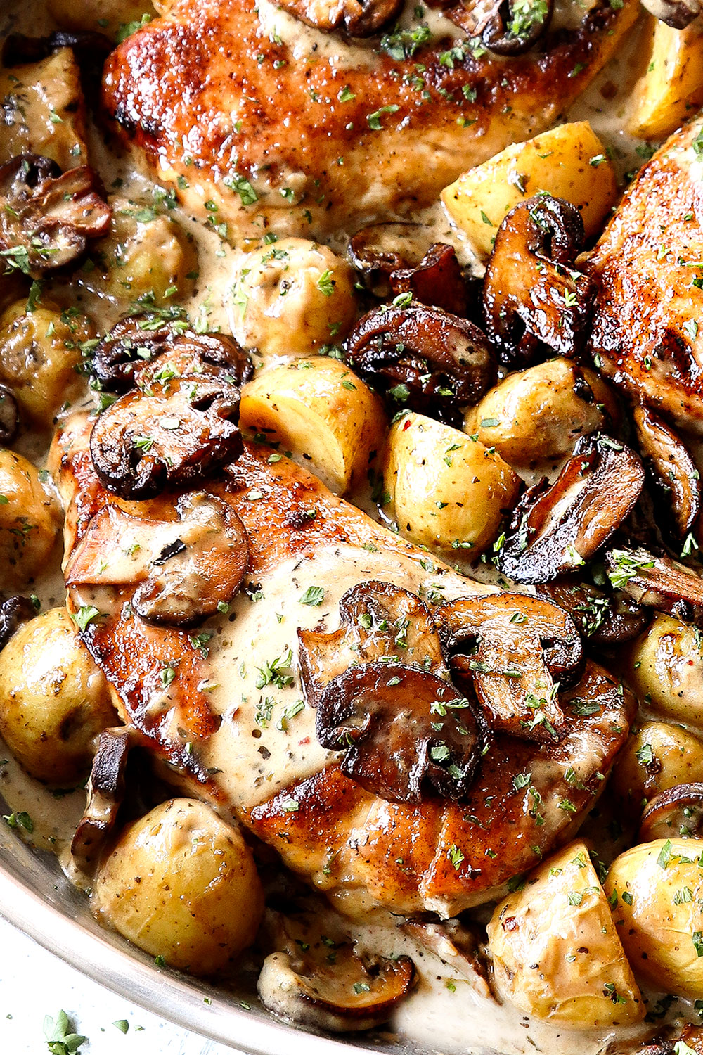 up close of mushroom chicken in a skillet with mushroom cream sauce