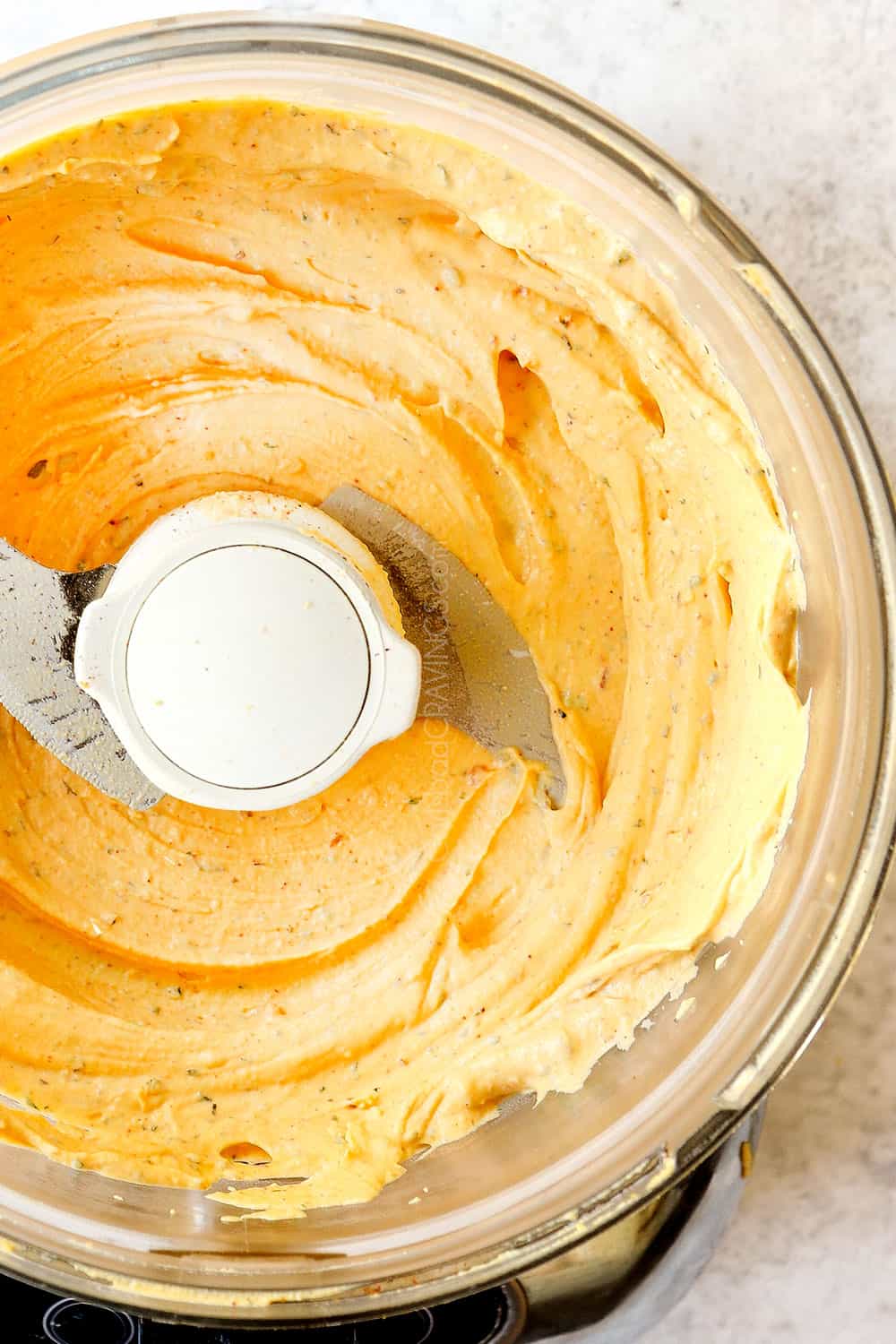 showing how to make deviled eggs by blending the filling ingredients in a food processor until super smooth and creamy