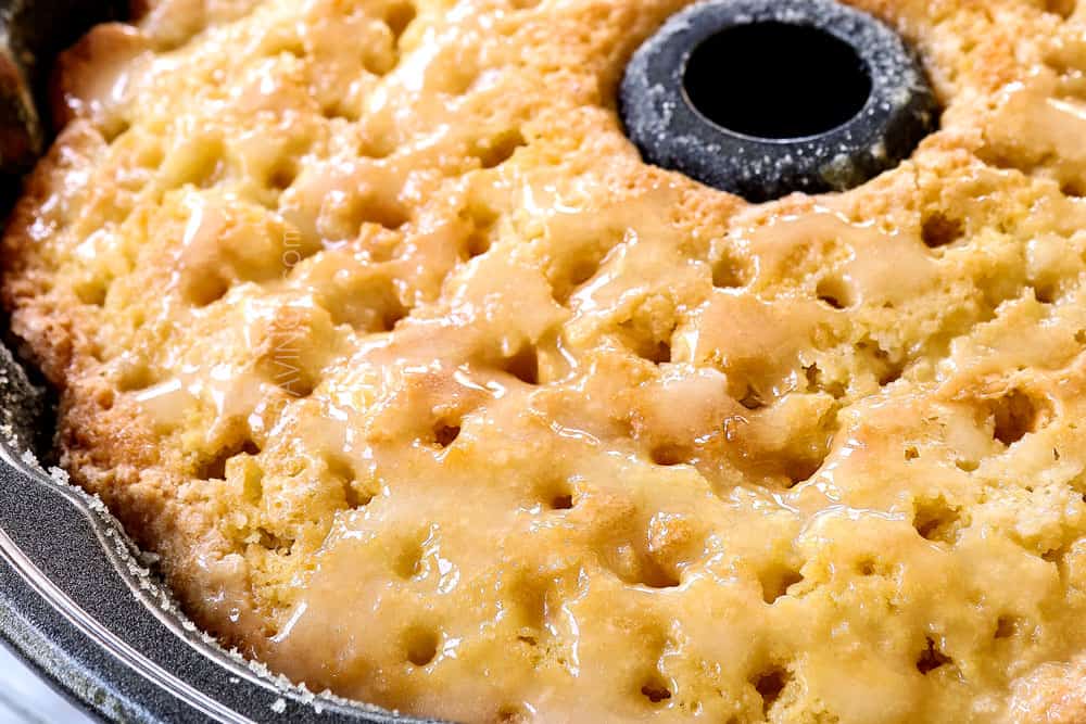 showing how to make lemon pound cake recipe by pouring lemon glaze into holes in the cake