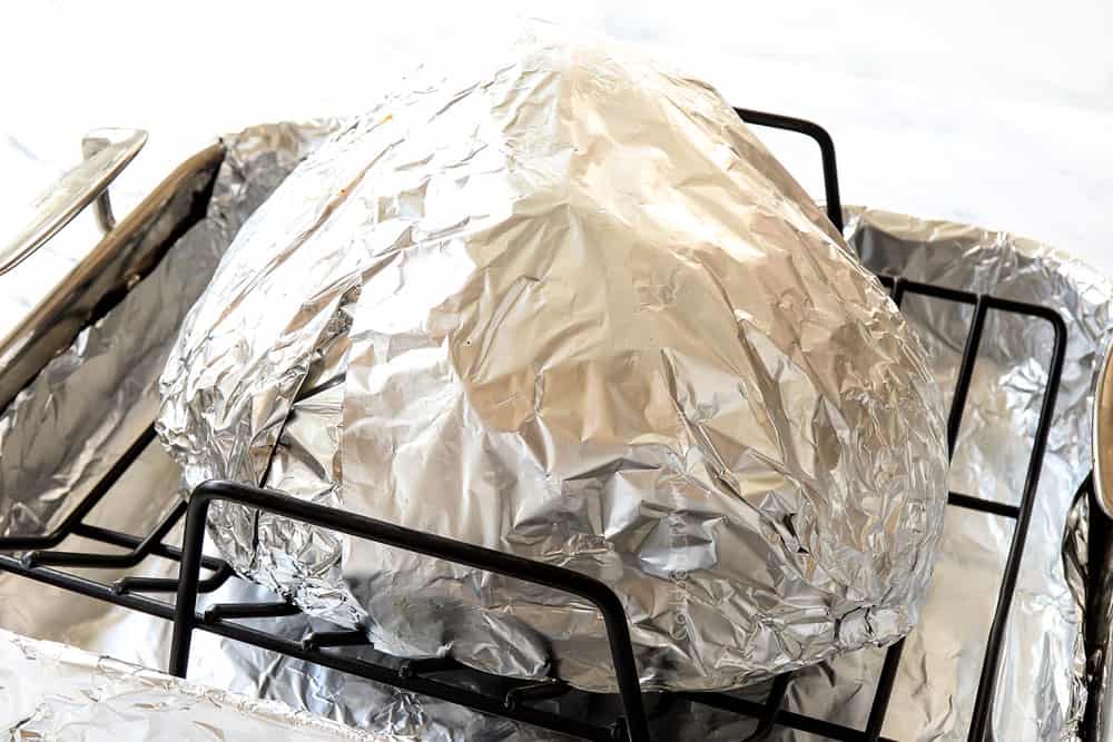 showing how to make spiral ham by wrapping spiral ham with foil and placing in a roasting pan