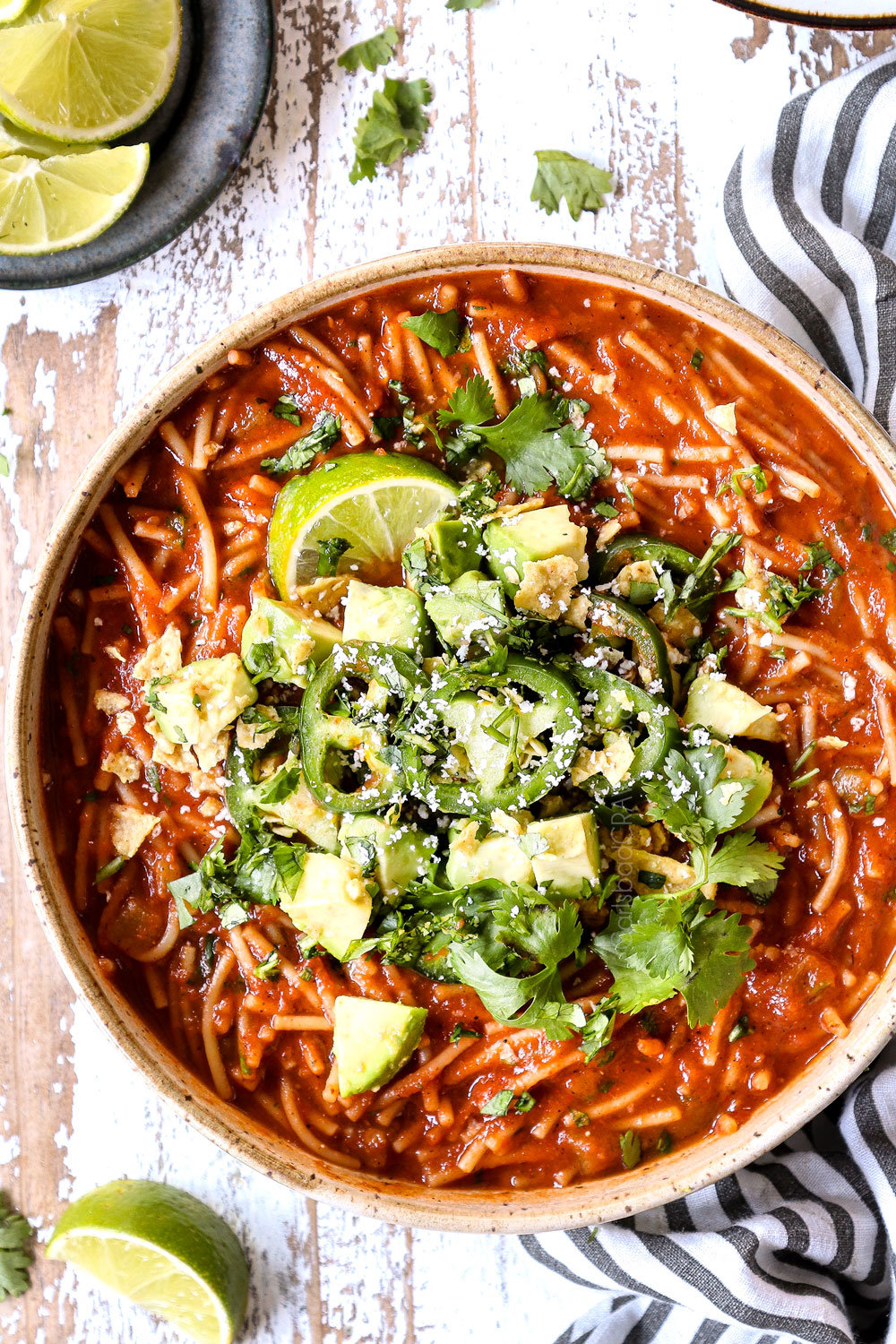 top view fideo soup in a bowl with cilantro and jalapenos