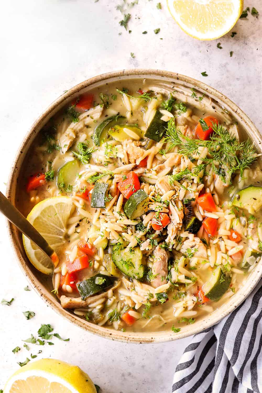 top view of a bowl of lemon chicken orzo soup